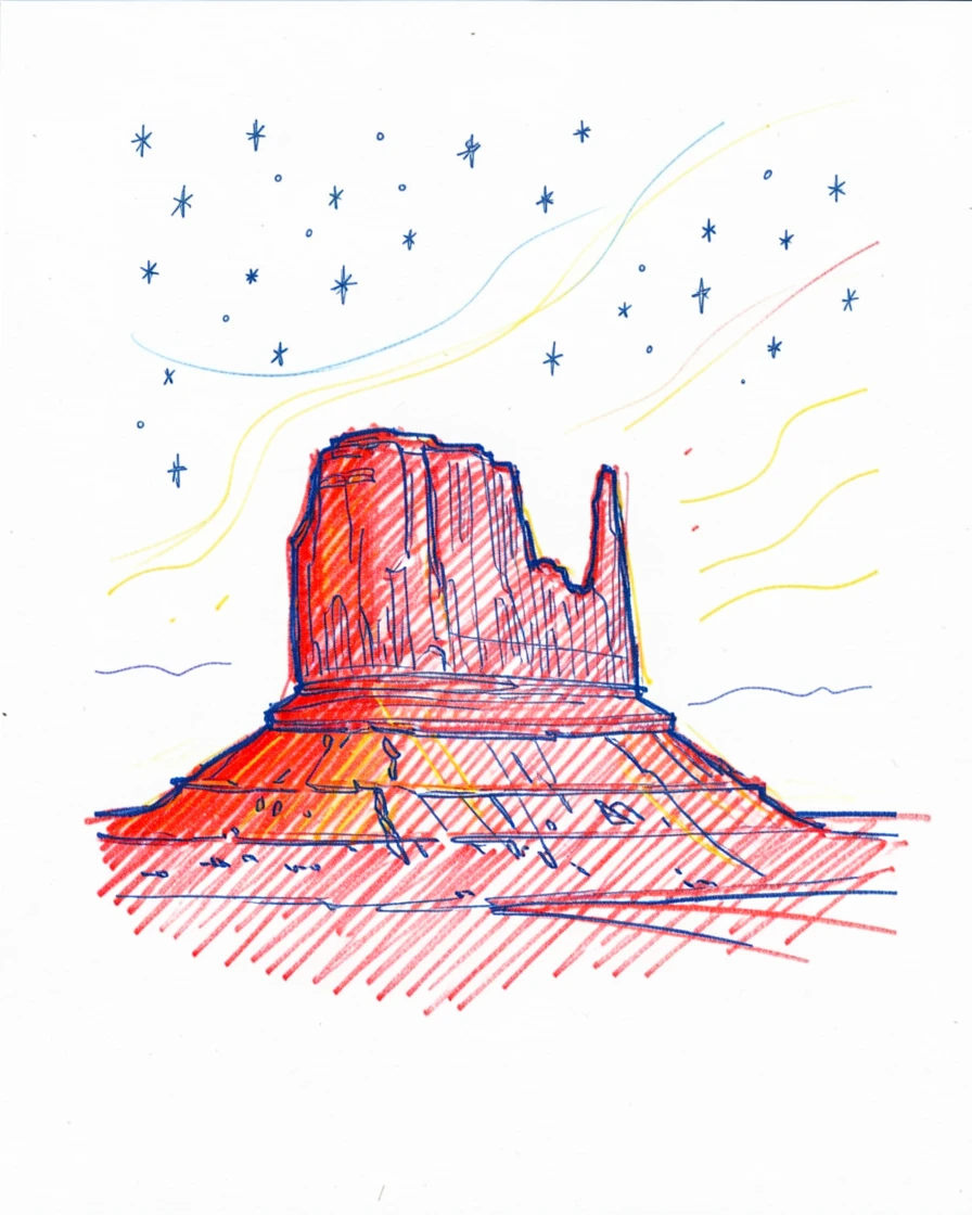 A high desert butte glowing red under a sky full of stars