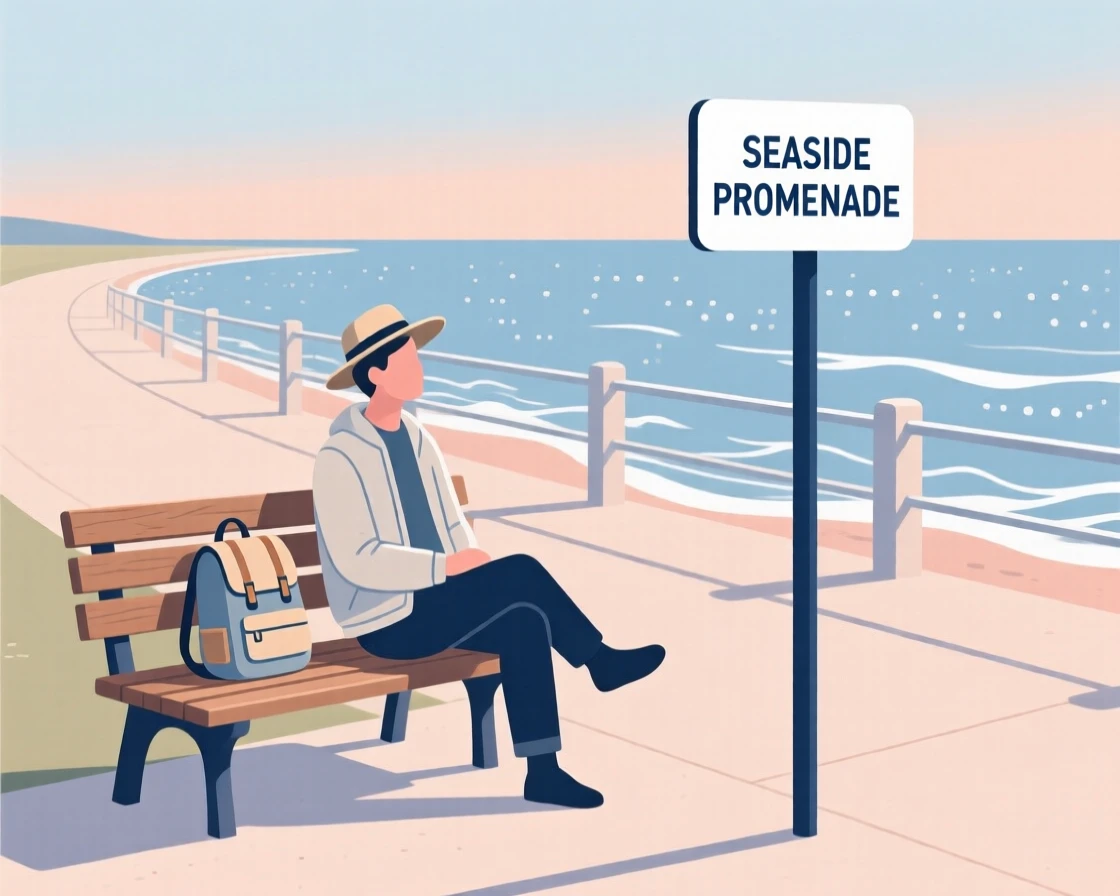 A traveler resting on a bench near a seaside promenade.