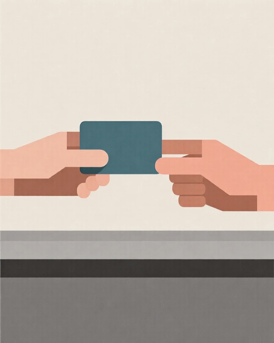 A pair of hands exchanging a credit card at checkout
