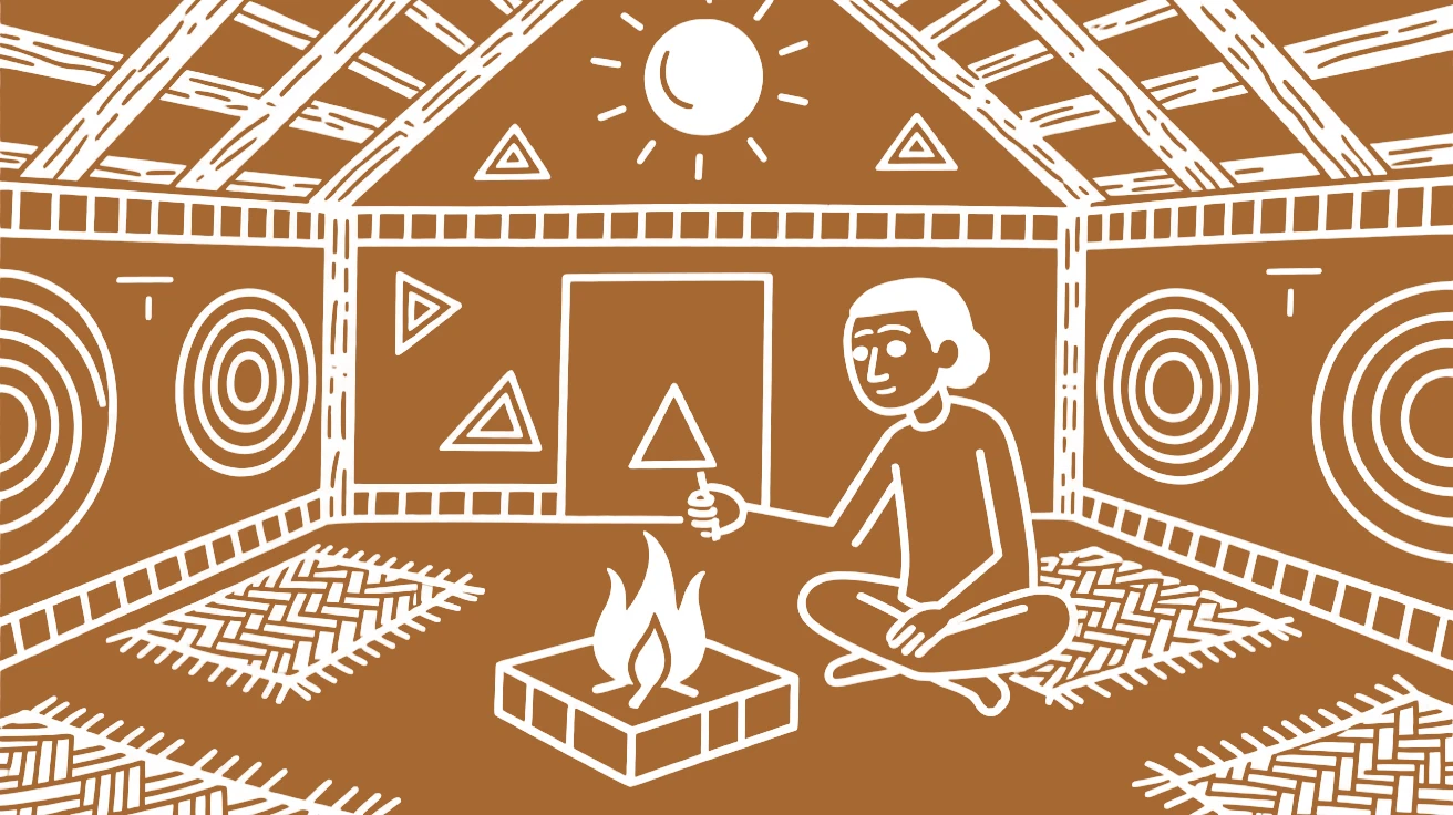 An elder lighting a sacred fire inside a modest village temple.