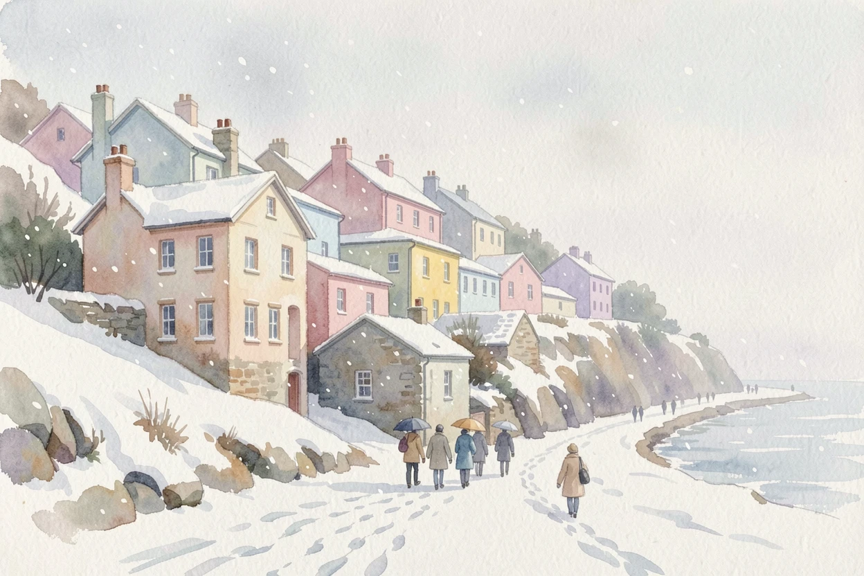A coastal town with pastel buildings stacked up a hillside during the first snow with travelers strolling along the path.