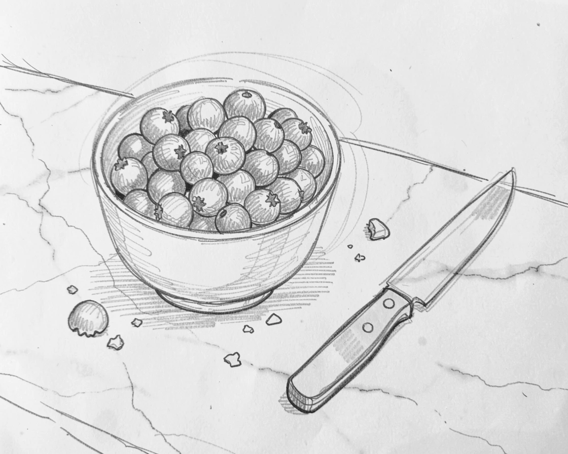 An appetizing still life of a bowl of ripe seasonal berries on a marble countertop, with crumbs and a knife resting beside it.