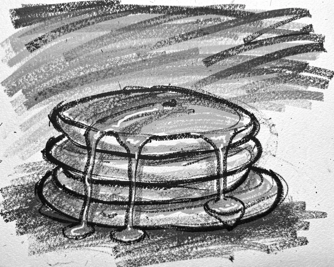 A stack of golden pancakes drizzled with syrup, beneath a sky streaked with sunset colors.