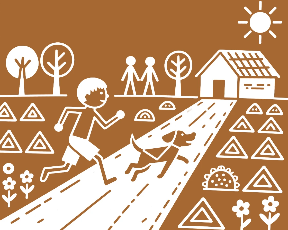 A boy and his pet dog racing each other down a village path.
