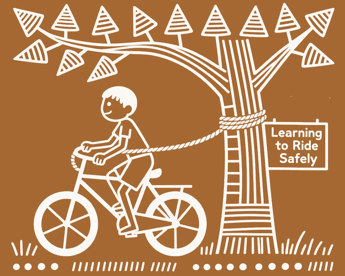 A young boy learning to ride a bicycle swinging from a rope tied to a tree branch.