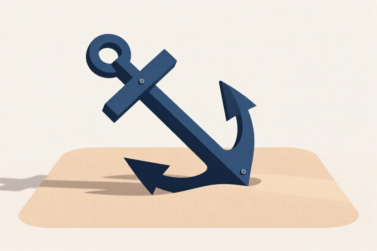 An anchor resting on calm sand