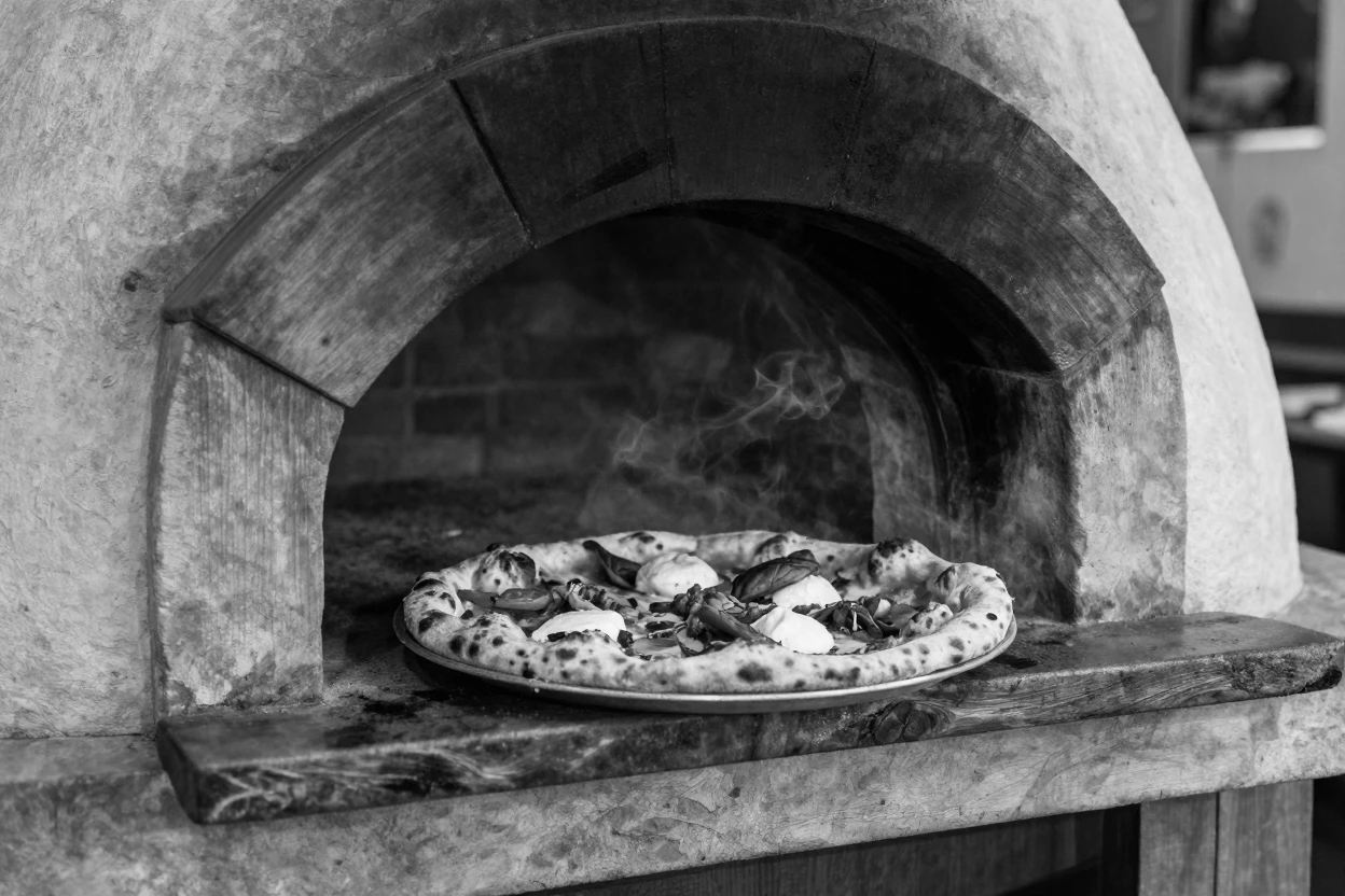 A wood-fired pizza emerges bubbling from a stone oven at a rustic Italian trattoria.