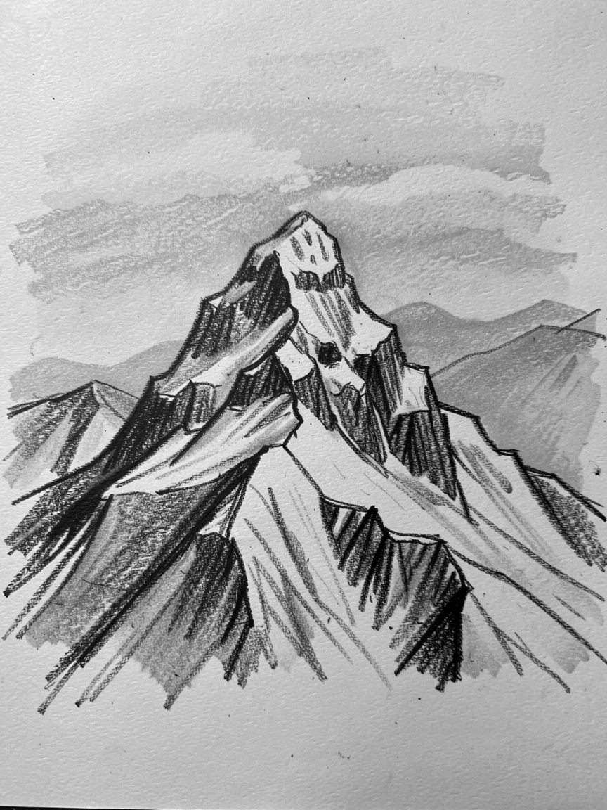 A snow-capped peak with distant mountains fading into blue haze.