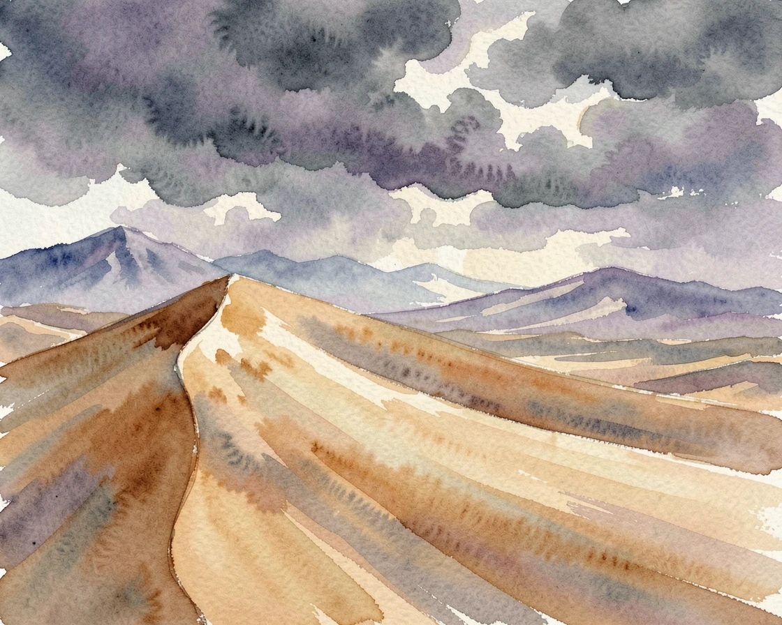 A sweeping desert dune as storm clouds gather with distant peaks fading into haze.